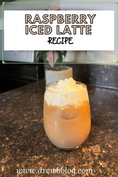 raspberry iced latte recipe in a glass on a granite countertop with text overlay