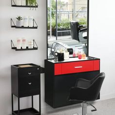 a black and red dresser sitting in front of a mirror