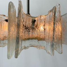 a glass chandelier hanging from a ceiling