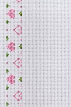 cross stitch pattern with pink and green hearts on white fabric, as well as the word love