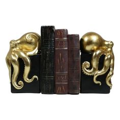 two golden octopus bookends sitting on top of each other