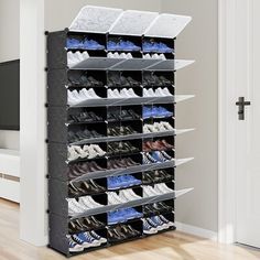 an organized shoe rack in the corner of a room