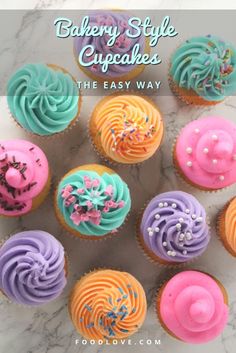 cupcakes with colorful frosting and sprinkles are arranged on a marble surface