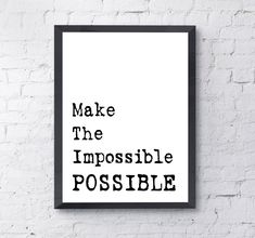 a black and white poster with the words make the impossible possible against a brick wall