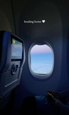 an airplane window with the words reading home on it