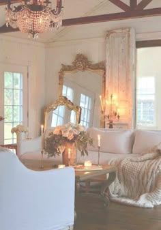 a living room filled with furniture and a chandelier