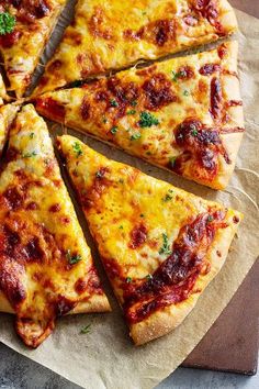 a sliced pizza sitting on top of a wooden cutting board