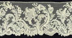 an embroidered lace with white flowers and leaves