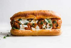 a meatball sub sandwich with cheese and herbs