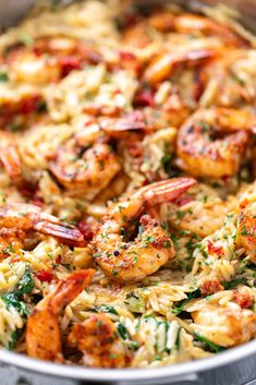 a skillet filled with shrimp and pasta