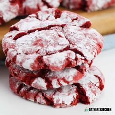 red velvet crinkle cookies stacked on top of each other with powdered sugar