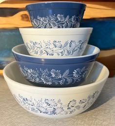 three blue and white bowls stacked on top of each other