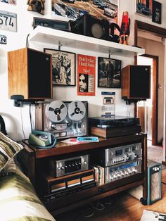 an old fashioned radio and stereo system in a room with many pictures on the wall