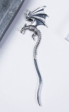 Add the fierce flame of fantasy to your hair with the Dracul Hair Stick! This beautiful accessory is shaped like a curved dragon that sits with its wings outstretched. Simply twirl and twist to create an easy updo! Measures 16cm long. Easy Updo, Alternative Jewelry, Easy Updos, Hair Stick, Jewellery Shop, Hair Sticks, Shop Necklaces, Necklaces Bracelets, Wicked