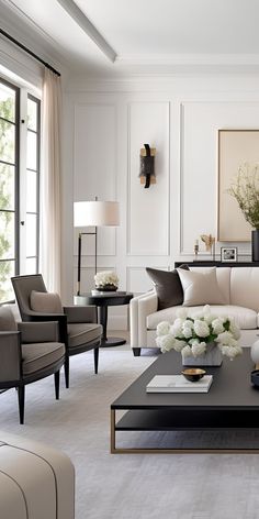 a living room filled with lots of furniture and flowers on top of a coffee table