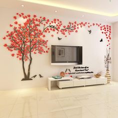 the living room is decorated in white and has red leaves on it, as well as a tree with birds