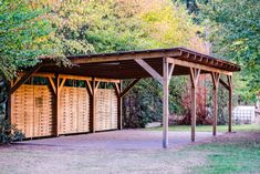 a wooden shelter in the middle of a park