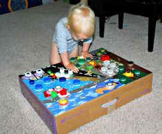 a toddler playing with legos on the floor in front of a coffee table