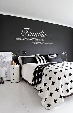 a bedroom with black and white decor on the walls