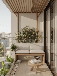 a couch and table on a balcony with potted plants