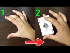 two hands holding playing cards with the numbers 1 and 2 in front of each other