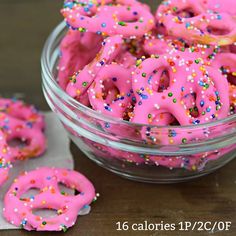 pink donuts with sprinkles in a glass bowl