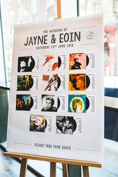 a poster is displayed on a easel in front of a window that says, the wedding of jayne & eoinn