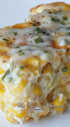 a close up of some food on a white plate with broccoli and cheese