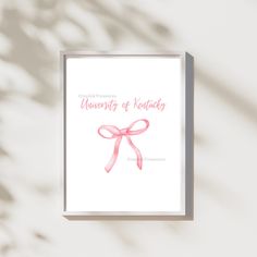 a card with a pink ribbon on it that says university of kentucky in cursive writing