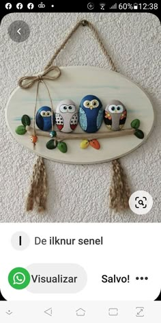 an image of three owls on a branch with leaves hanging from the ceiling and texting below