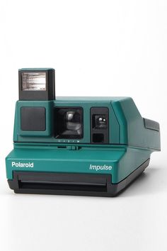 a polaroid camera sitting on top of a white table