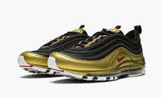 This colorway of the Nike Air Max 97 first released in November 2018.  It is inspired by the OG "Metallic Gold" color scheme.  The upper is composed of black mesh with reflective black overlays.  Metallic gold hits inspired by the 1997 OG are used on the mudguard, tongue, and midsole.  Red branding on the side panel, tongue, and heel tab are also pulled from the original design. 97 Shoes, Nike Air Max 97 Black, Metallic Gold Color, Chicano Art Tattoos, Sneakers Jordans, Rare Nikes, Shoes Sneakers Jordans, Sneakers Collection, Fresh Shoes