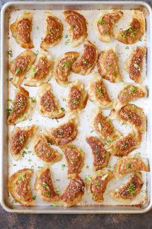 a pan filled with dumplings covered in sauce