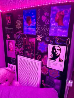 a bedroom with pink lights and posters on the wall