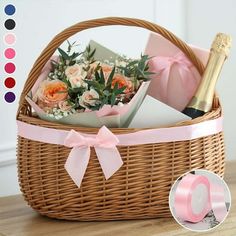 a wicker basket with flowers and champagne in it on a wooden table next to other items