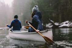 two people in a canoe paddling through the water