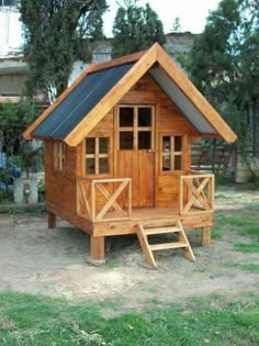 a small wooden house with windows and doors