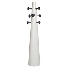 a tall white vase with four black knobs