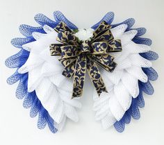 a blue and white wreath with a bow on it