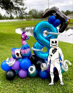 an image of a balloon sculpture in the shape of number three and a man standing next to it