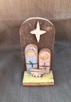 an old wooden toy with two doors and a star on top