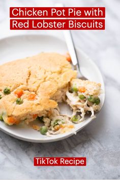 the chicken pot pie with red lobster biscuits is on a white plate next to a fork