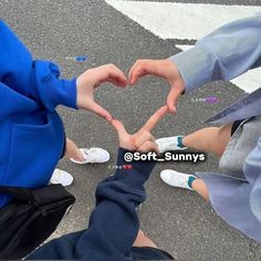 two people making a heart with their hands