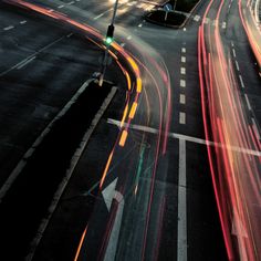 an overhead view of a city street with traffic lights and signs at night time,