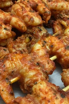 some chicken skewers are on a plate with toothpicks