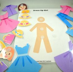 paper dolls and dress up girl cutouts on a table