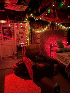 a bedroom with red lights and decorations on the walls