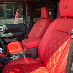 the interior of a vehicle with red leather seats