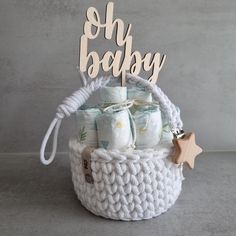 a basket with baby items and a wooden sign