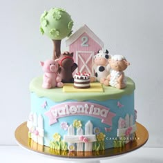 a birthday cake with farm animals on top